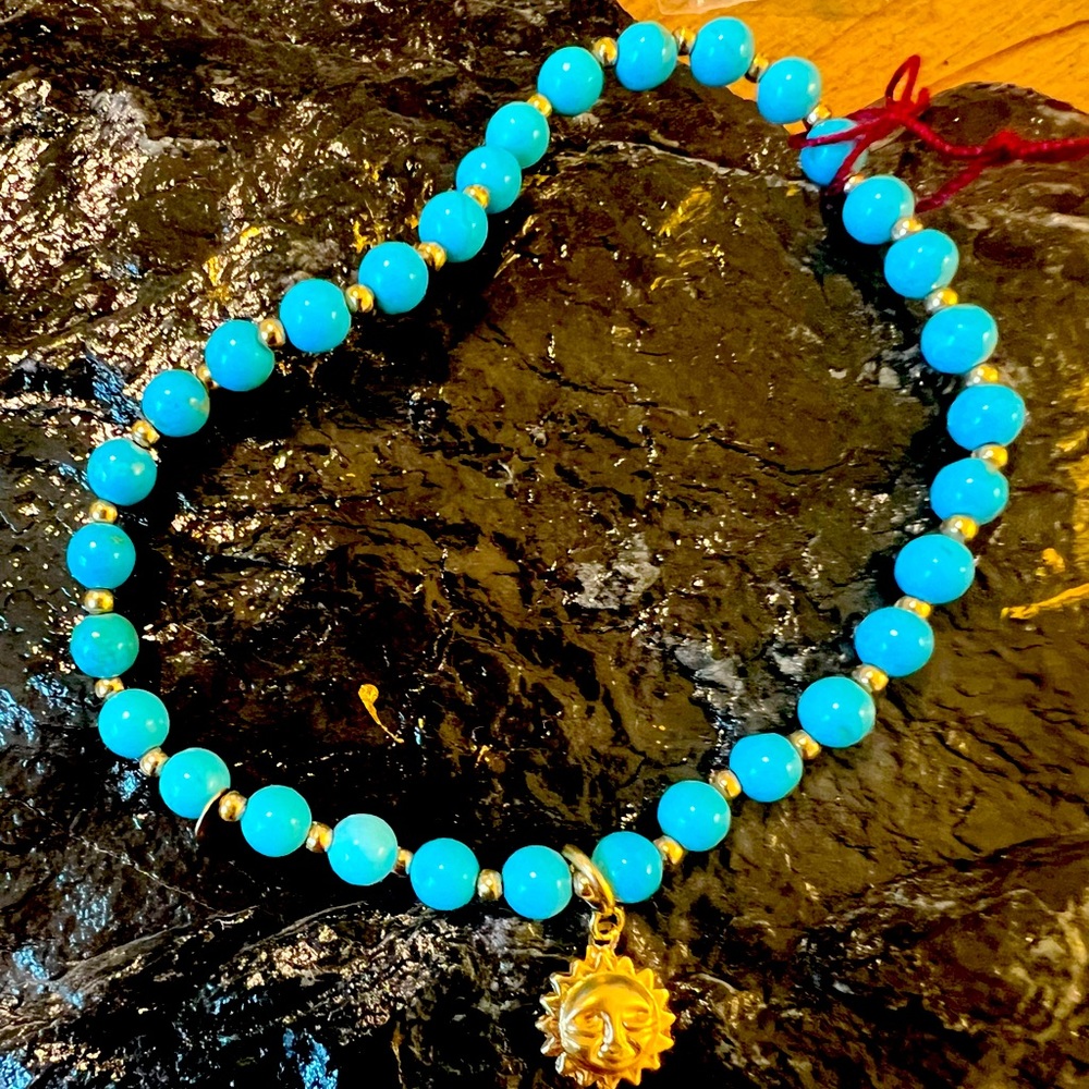Bracelet. Natural turquoise and 14k gold spacer and 14k gold charm.